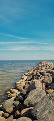 Stone Pier Stretching into the Baltic Sea under Clear Blue Sky in Latvia