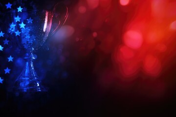A gleaming trophy, partially obscured by a blue, star-patterned overlay, set against a blurred red and blue bokeh background