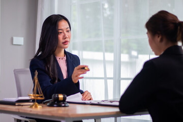 Fototapeta premium Professional female lawyer in a corporate setting discusses legal contracts and justice, advises executives on deals, partnerships and court decisions.