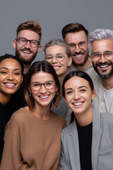 Obraz premium Group of diverse young adults smiling happily together in a friendly, positive social setting