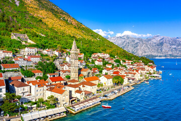 Fototapeta premium View of the historic town of Perast at famous Bay of Kotor on a beautiful sunny day with blue sky and clouds in summer, Montenegro. 