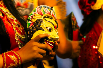 Mask dancer holding a traditionil east java mask
