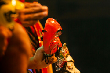 Mask dancer holding a traditionil east java mask