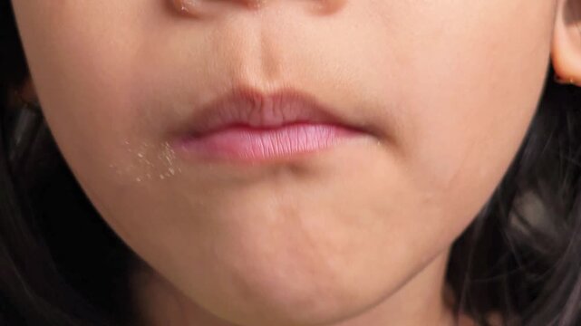 Little Girl Enjoying Sweet Treat CloseUp of Delicious Bite.