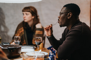 A warm indoor setting featuring friends dining together, fostering community and relaxation with food.