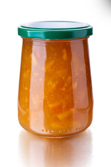 Orange marmalade in a glass jar with a green cap isolated on white with clipping path included