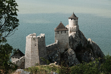 Close-up top view of the towers of Golubac Fortress perched on a rocky hill above the Danube River in Serbia country.