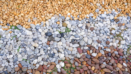 Pebble stone garden floor decoration background, Multicolor river pebblestone pattern on the ground in home front yard gardening area, High angle view