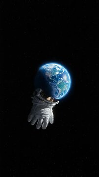 Astronaut reaching towards Earth in deep space