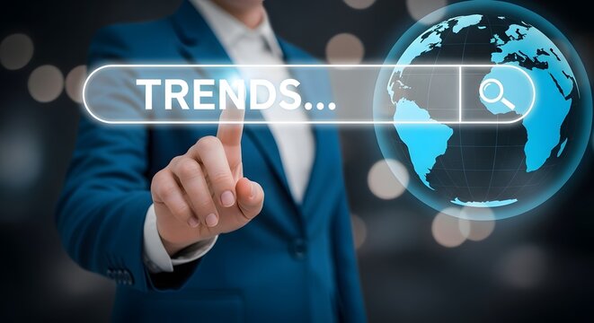 Businessman touching transparent digital screen with glowing TRENDS text and global map interface for future business insights


