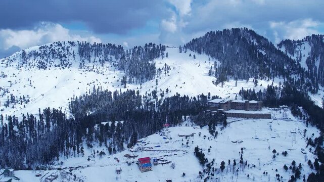 Aerial view of a snowy mountain resort, featuring a ski slope, hotel, and stunning winter scenery. Malam Jabba hill station.