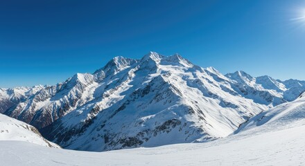 Obraz premium Majestic Snow-Capped Peaks Under a Clear Winter Sky
