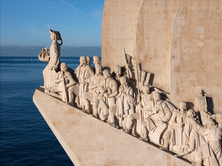 Aerial view of the stark white PadrÃ£o dos Descobrimentos monument juts into the deep blue sea, Lisbon, Lisboa, Portugal.