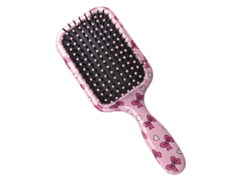 Pink paddle hairbrush with bow design isolated
