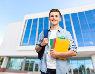 portrait of a young man holding a folder at school