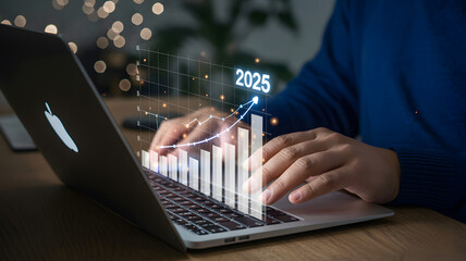 Analyzing 2025 business growth on laptop with data chart overlay showcasing upward financial trends