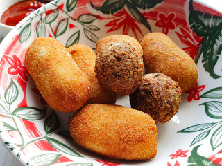 Fried party snacks: kibbeh, risole, and fried rolls. Typical Brazilian food in a bowl