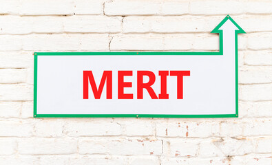 Obraz premium Merit symbol. Concept word Merit on beautiful white sign on old white brick wall. Beautiful brick old white wall background. Business lifestyle merit concept. Copy space.