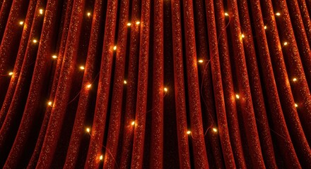 Close-up of a red velvet curtain with small, warm lights interspersed throughout the fabric.