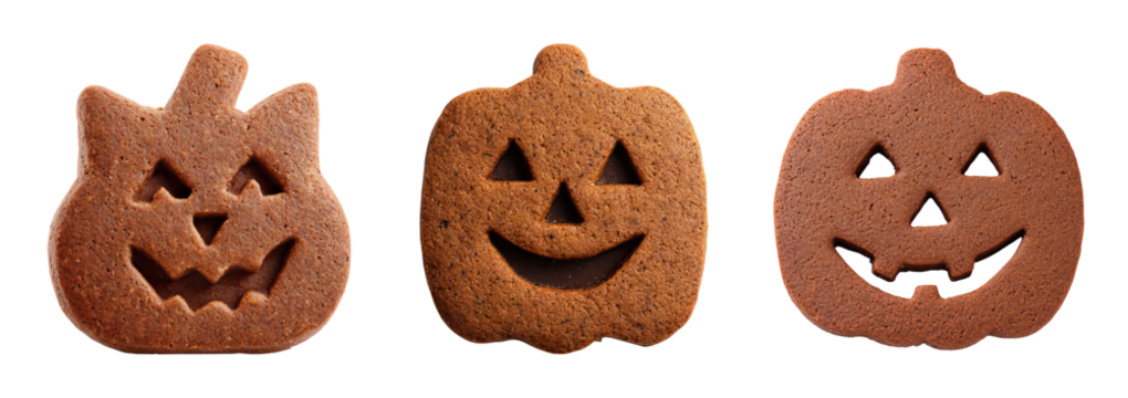 Halloween dessert gingerbread cookies shaped like pumpkin faces with carved eyes and mouths in festive spooky style