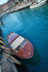 Venetian water taxi boat parked near the taxi peer
