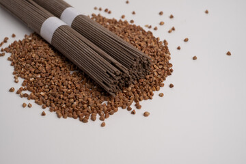 Packet of dry soba, raw buckwheat and rice noodles, uncooked buckwheat pasta, gluten free soba spaghetti on white background.