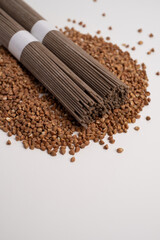 Packet of dry soba, raw buckwheat and rice noodles, uncooked buckwheat pasta, gluten free soba spaghetti on white background.