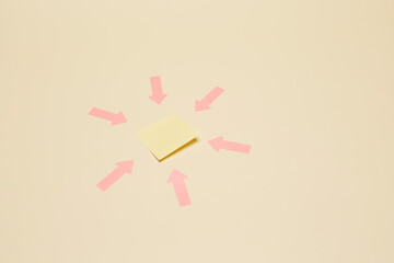 Six red arrow stickers pointing from different directions to the one sticker note sheet located in the center