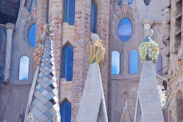 Colorful fruit sculptures and tower details on the Sagrada Familia in Barcelona, Spain