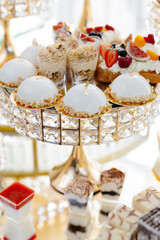 Delicious macarons and pastries decorating a luxurious candy bar buffet