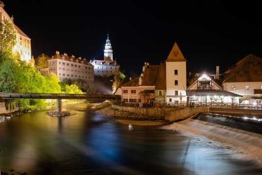 A Night Scene Cesky Krumlov, a medical town situated by the Vltava River and feather with a Renaissance and Baroque cattle and tower.