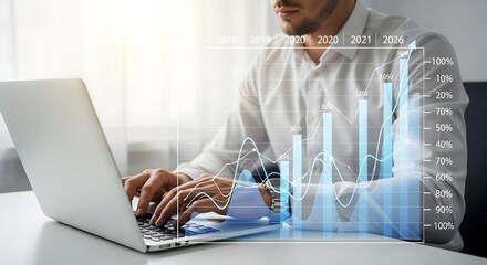 Business analytics: man analyzing financial data on laptop with growth chart