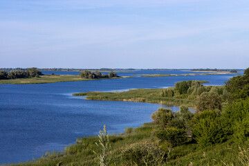 Russian landscape with Volga river on a sunny day. Bolgar, Tatarstan, Russia. View on the valley of Volga river from the hill. Peaceful nature. Beautiful background.