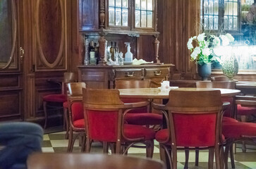 Elegant dining room in a hotel in Argentina featuring wooden decor and red seating