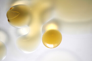 Abstract image of golden liquid droplets on a white background