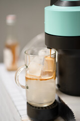 Capsule coffee machine with espresso cup and making coffee.