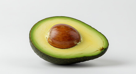 Vibrant green avocado half, perfectly ripe with a prominent seed, presented against a clean white background, emphasizing healthy eating and freshness.