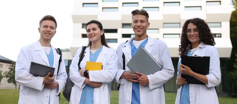 Group of medical students in uniforms near building outdoors