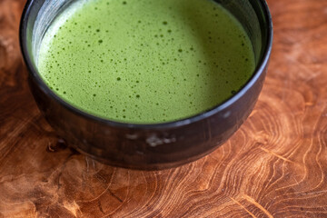 Closeup photo of traditional Japanese bowl with fresh green matcha tea