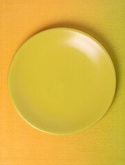 Empty green plate on smooth gradient background ideal for text placement