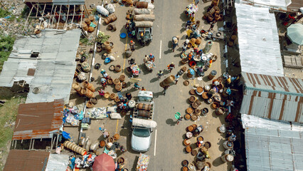 Ipare, Nigeria - 22 November 2024: Aerial view of a bustling market street, where vibrant colors of goods contrast with the dull tones of the road.