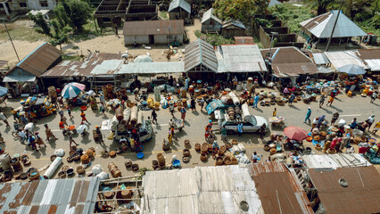 Ipare, Nigeria - 22 November 2024: Aerial view of a bustling marketplace where vibrant colors and textures interplay amongst the crowded stalls and pathways.