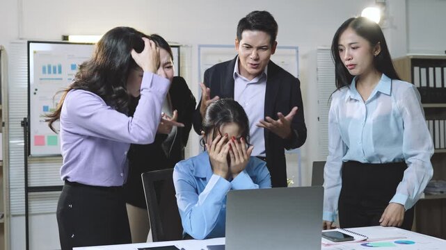 Distressed female professional breaking down while corporate team members verbally criticize and point fingers during tense workplace confrontation