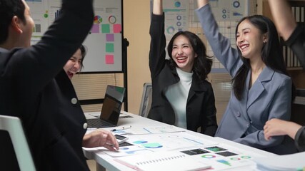 Professional team celebrating successful project milestone, sharing excitement and mutual recognition through handshakes and positive energy in corporate meeting space - Powered by Adobe