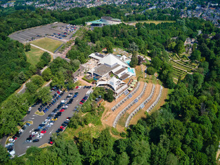 Aerial view of Thermae 2000, a modern spa complex, nestled amongst the green hills, with parking lots and terraced gardens, Valkenburg, Limburg, Netherlands.