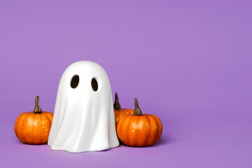Funny Halloween ghost with Halloween pumpkins with space for text. Halloween concept background