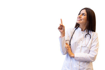Female doctor wearing lab coat and stethoscope pointing up with index finger, smiling and looking up on a transparent background