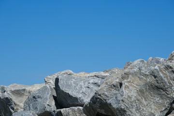 Graphic image of gray breakwater rocks on the Nova Scotia Coast