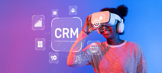 A young woman smiles while exploring a vibrant virtual reality environment related to customer relationship management. The scene highlights technology and engagement. XDMCP
