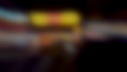 Abstract blurred urban night lights with warm yellow and orange tones creating a dreamy bokeh effect for backgrounds